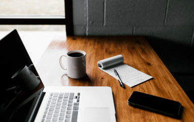 laptop with notepad and coffee